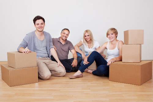 Furniture and boxes being moved by a removals van team